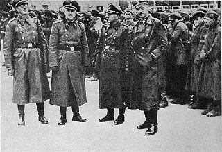 SS officers posing in front of a newly arrived transport of Soviet prisoners of war. Mauthausen
